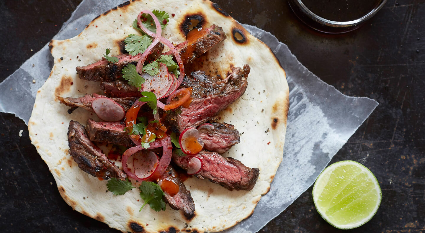 Sliced steak on a tortilla Sliced steak on a tortilla