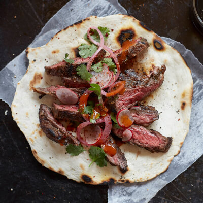 Sliced steak on a tortilla Sliced steak on a tortilla