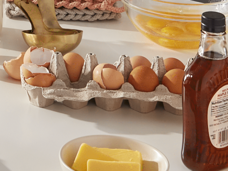 A carton of eggs, some of which are cracked