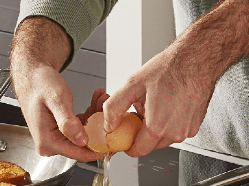 Hands cracking an egg