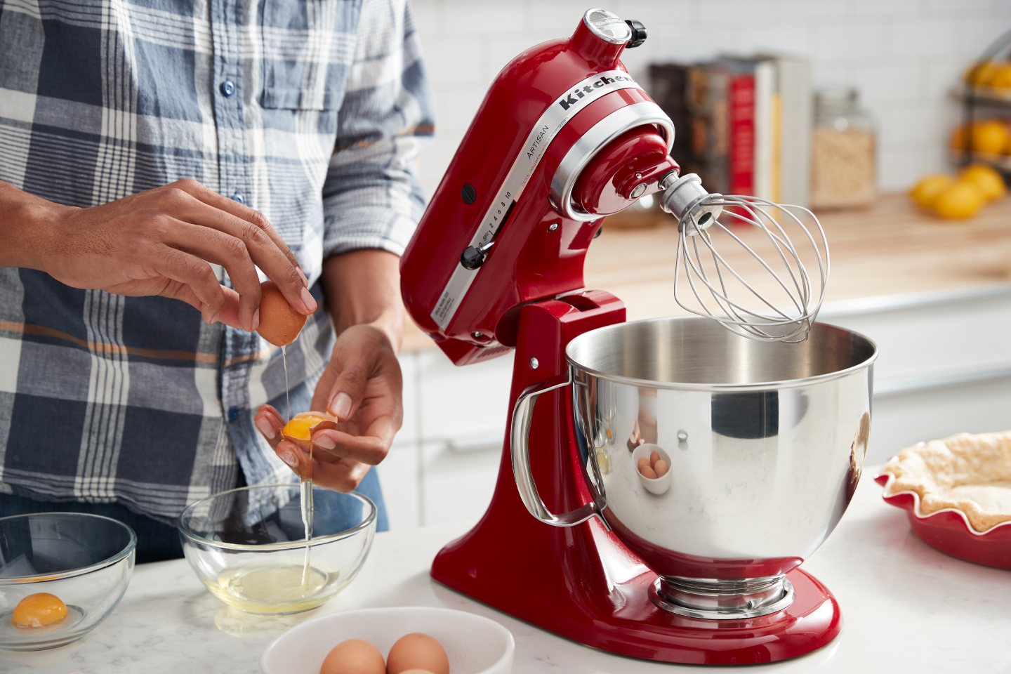 Hands slipping egg yolks between shells Hands slipping egg yolks between shells
