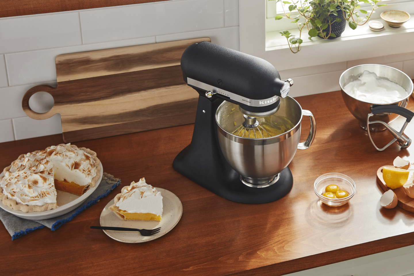 A pie plate of meringue pie with a slice cut out A pie plate of meringue pie with a slice cut out