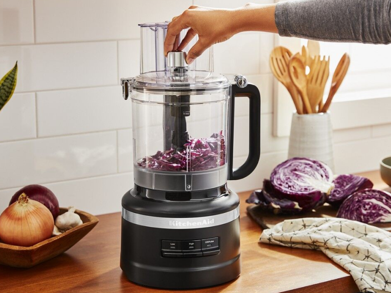 Woman dicing vegetables in a KitchenAid® food chopper Woman dicing vegetables in a KitchenAid® food chopper