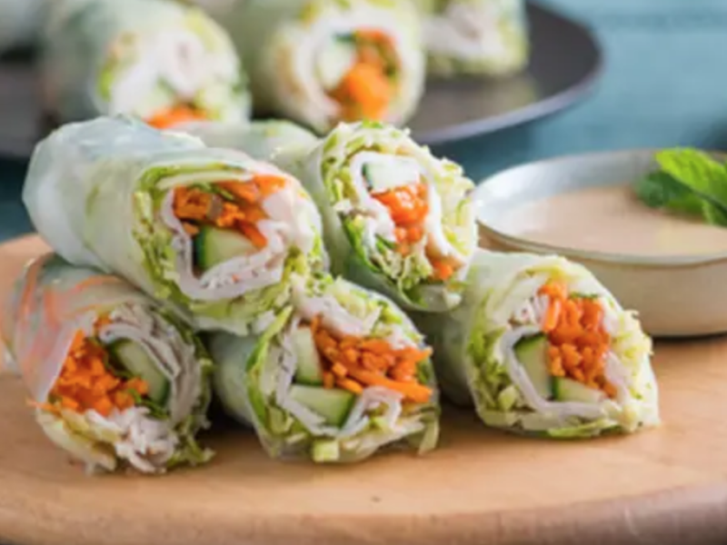 Spring rolls on a wooden cutting board Spring rolls on a wooden cutting board