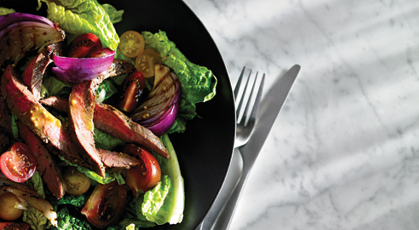 Close-up of tossed salad with steak and sliced tomatoes Close-up of tossed salad with steak and sliced tomatoes