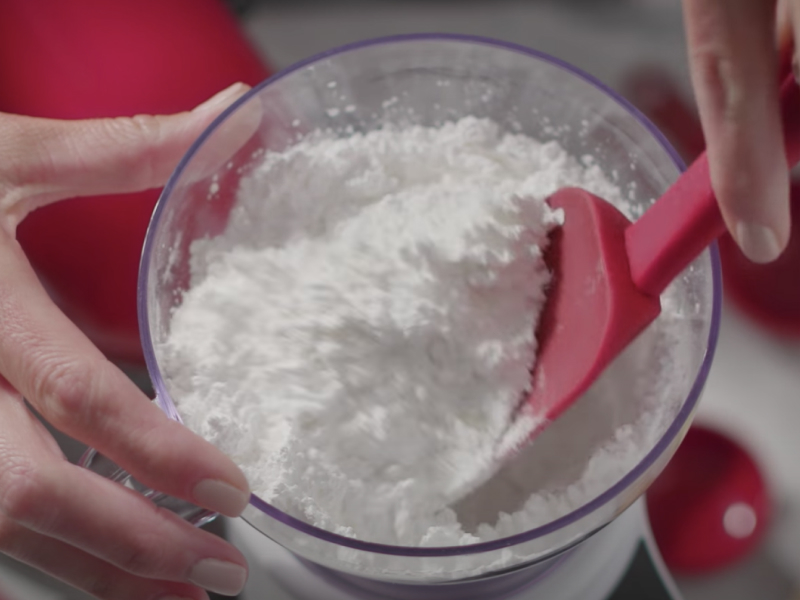 Spatula breaking clumps of flour