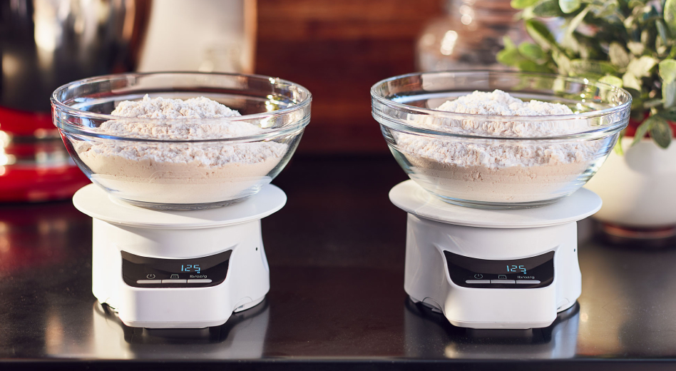 Two bowls of flour on two scales  Two bowls of flour on two scales