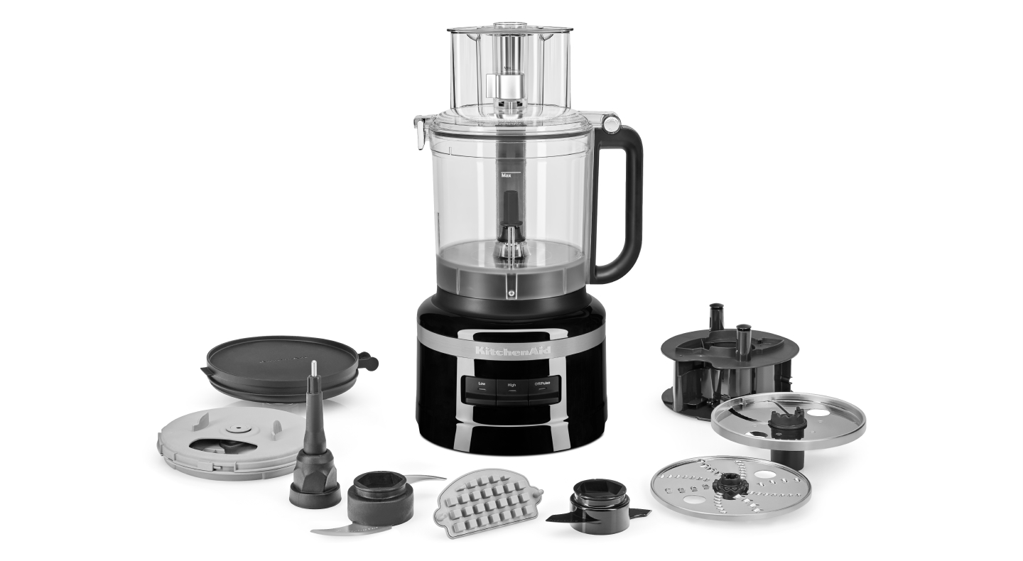 A KitchenAid® food processor with an array of attachments
