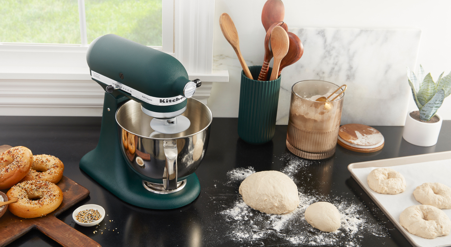 Bagel dough on a countertop next to a blue-green KitchenAid® stand mixer Bagel dough on a countertop next to a blue-green KitchenAid® stand mixer