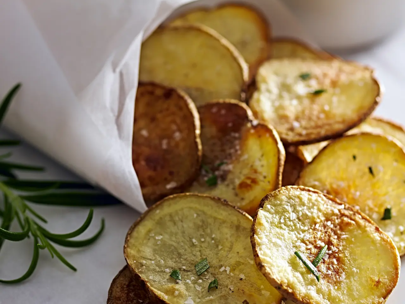 Homemade potato chips garnished with chives Homemade potato chips garnished with chives