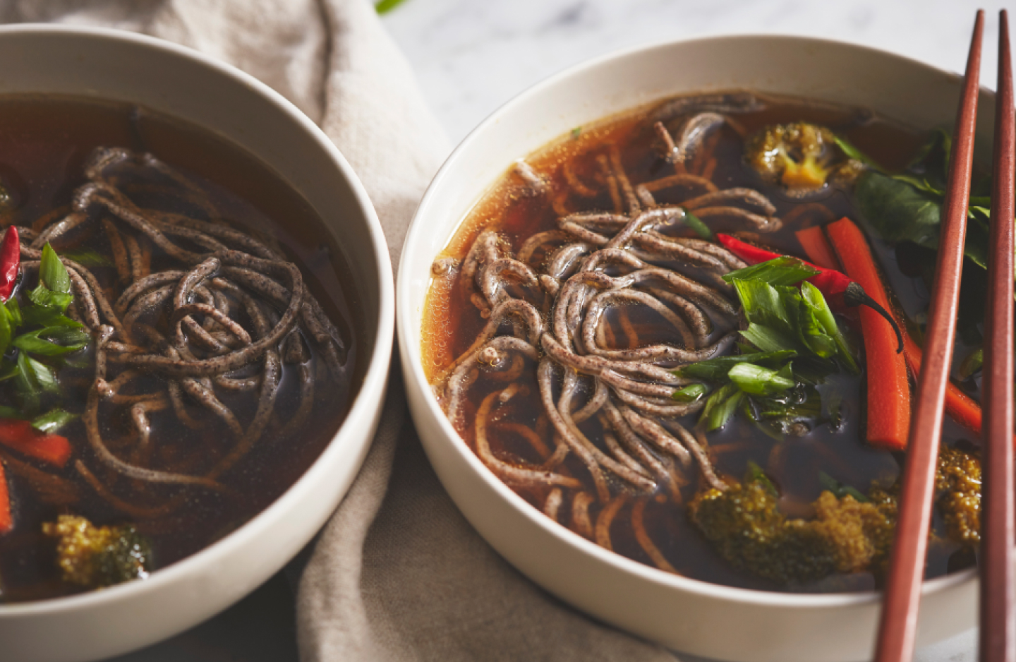 A bowl of buckwheat noodles in an Asian beef broth A bowl of buckwheat noodles in an Asian beef broth