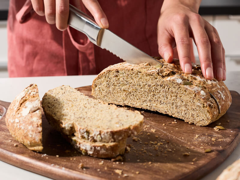 Person slicing bread