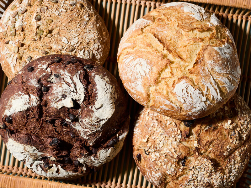 Four loaves of bread in a basket Four loaves of bread in a basket