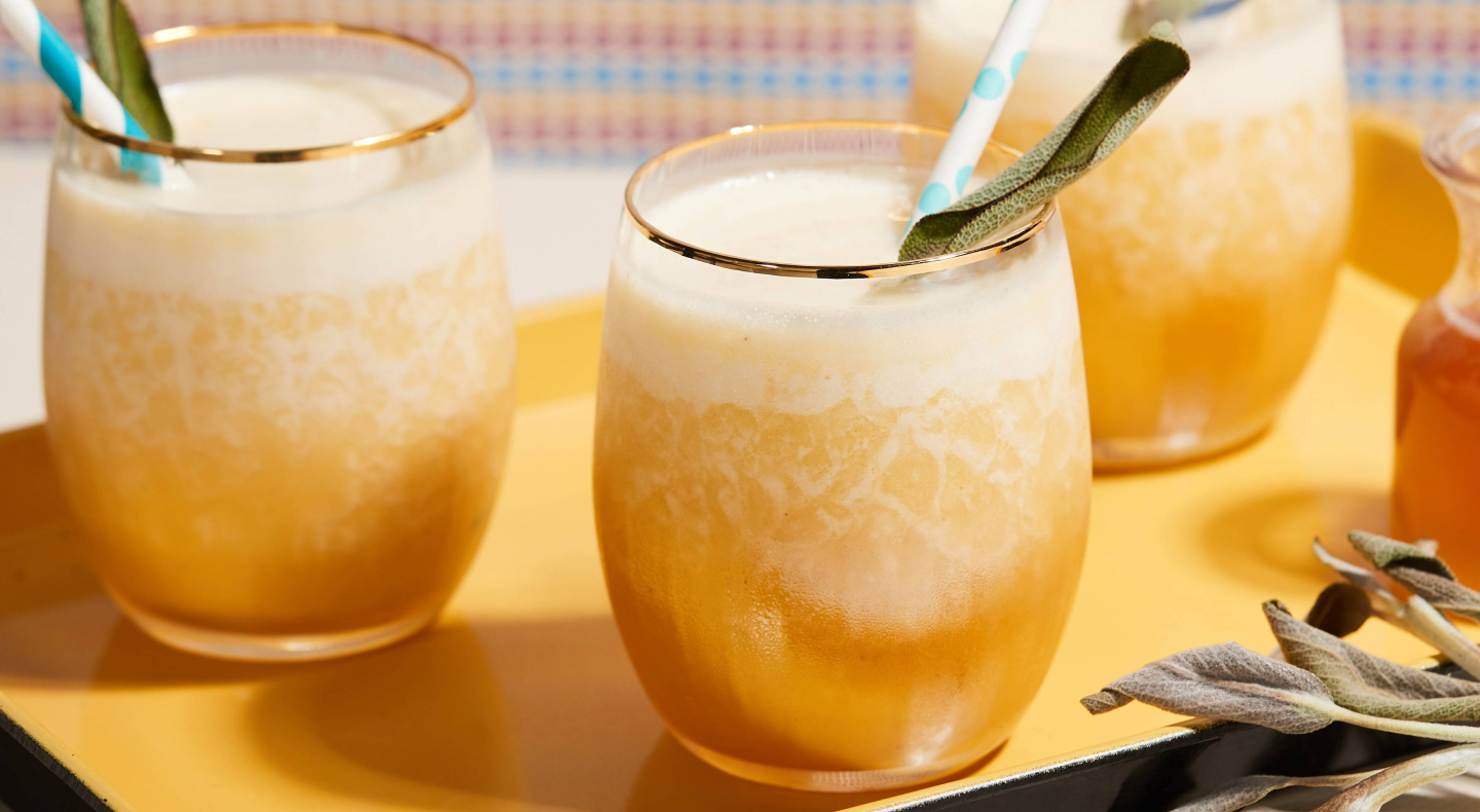 Fresh juice in serving cups with fruit pieces, straws and spoons Fresh juice in serving cups with fruit pieces, straws and spoons