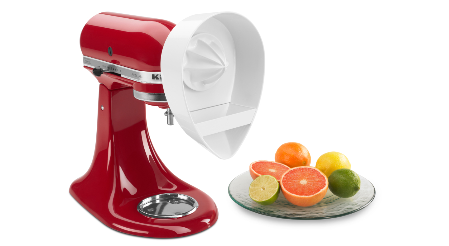 Sliced fruits next to a red KitchenAid® stand mixer with Citrus Juicer Attachment Sliced fruits next to a red KitchenAid® stand mixer with Citrus Juicer Attachment