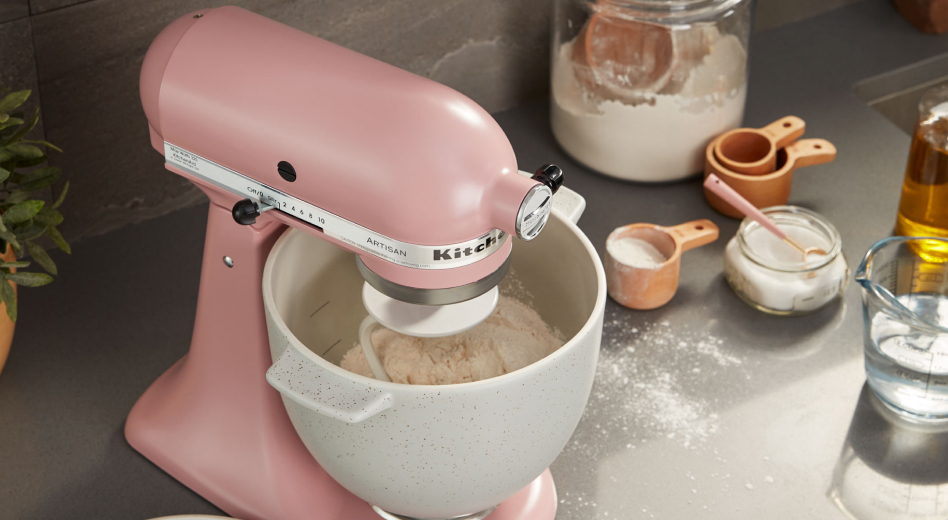 A pink KitchenAid® stand mixer with baking ingredients. A pink KitchenAid® stand mixer with baking ingredients.