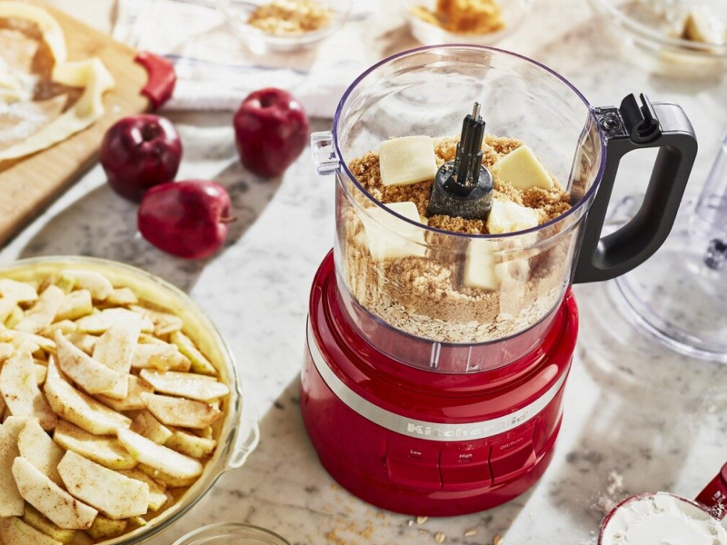 A food processor with butter and graham crackers