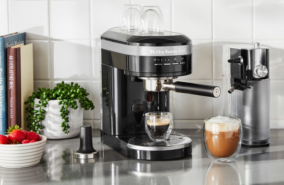 Black espresso machine with milk frother attachment and drinks Black espresso machine with milk frother attachment and drinks