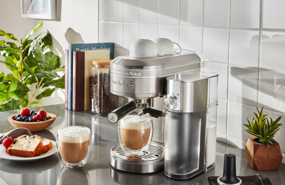 Stainless steel espresso machine on counter with cappuccinos Stainless steel espresso machine on counter with cappuccinos