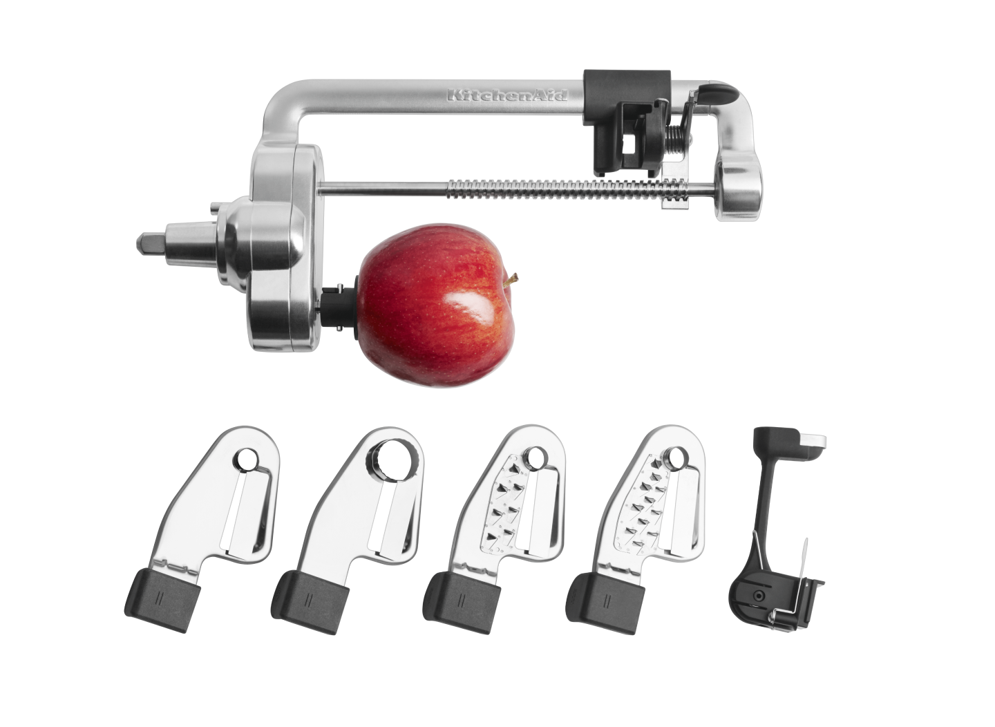 Stand mixer blade attachments and an apple. Stand mixer blade attachments and an apple.
