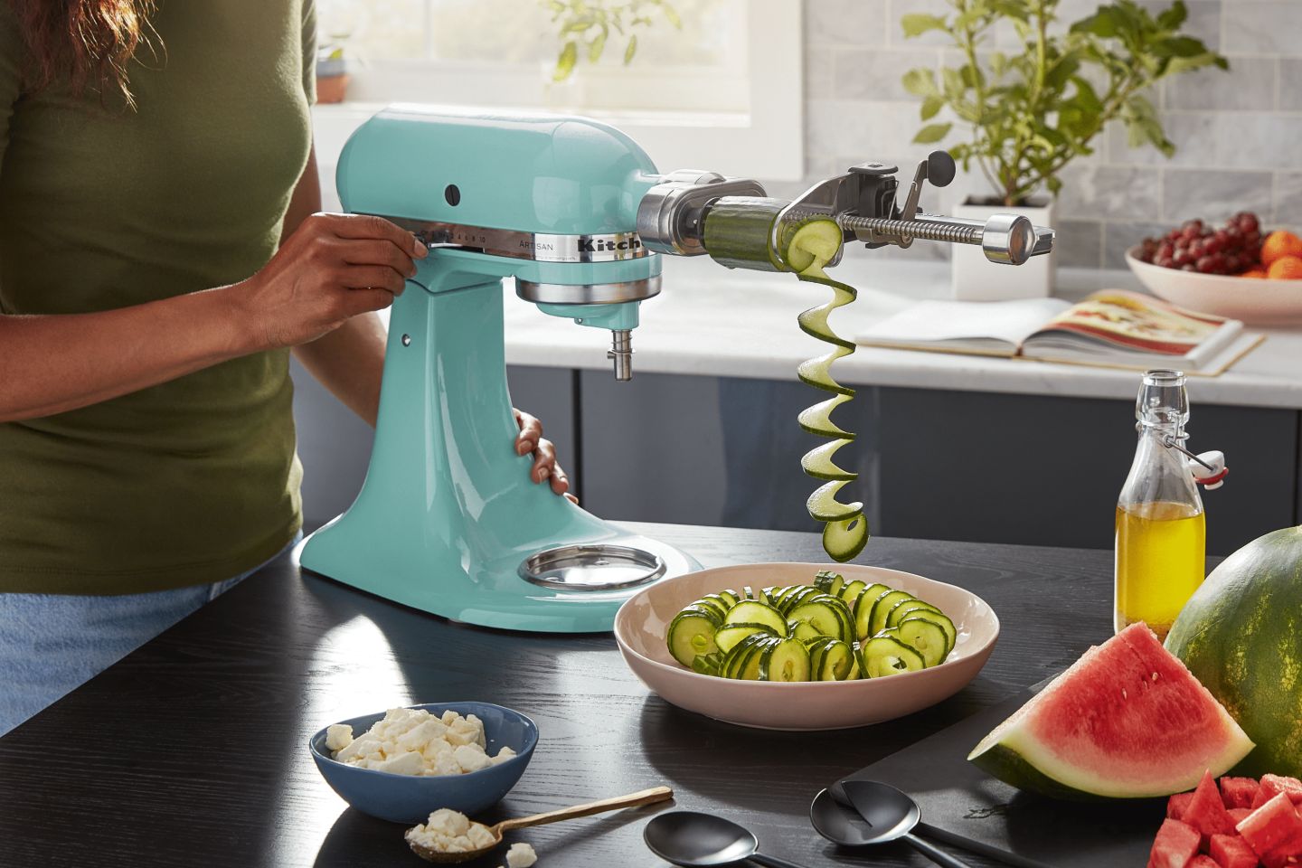 A teal KitchenAid® Stand Mixer and zucchini spirals. A teal KitchenAid® Stand Mixer and zucchini spirals.