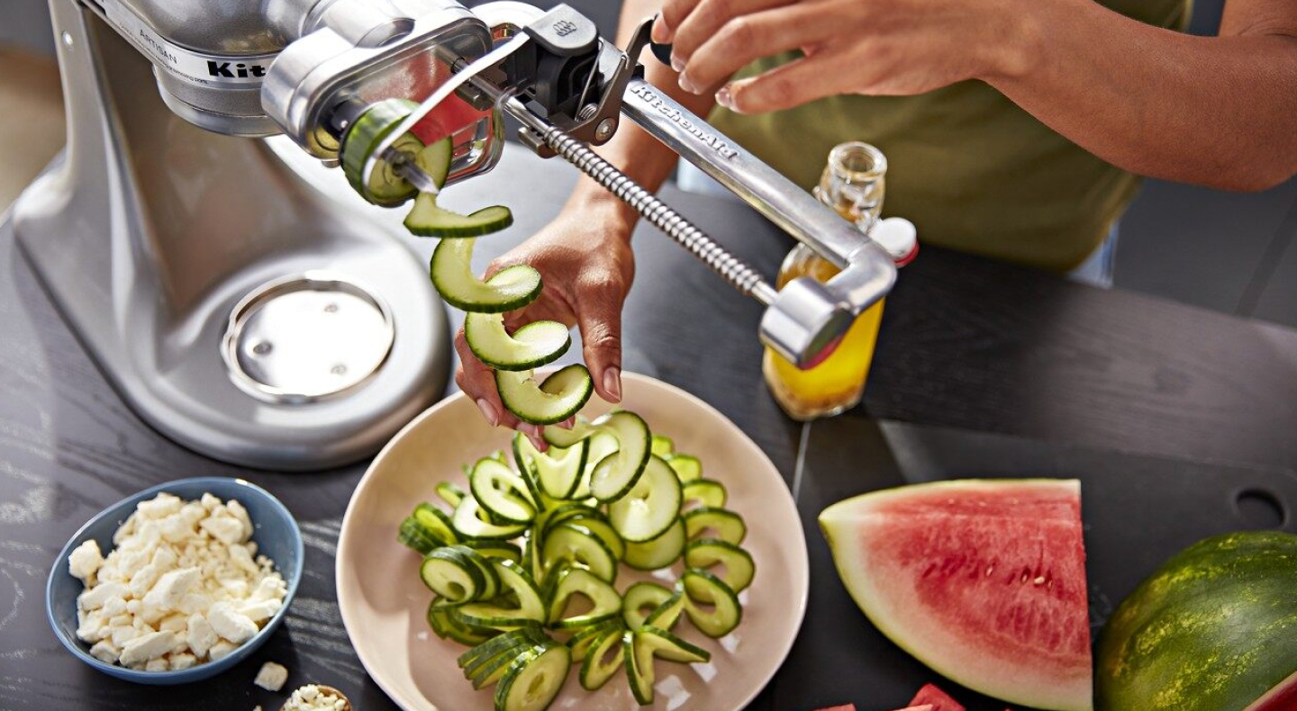 Person using 7 Blade Spiralizer Plus with Peel, Core and Slice attachment Person using 7 Blade Spiralizer Plus with Peel, Core and Slice attachment