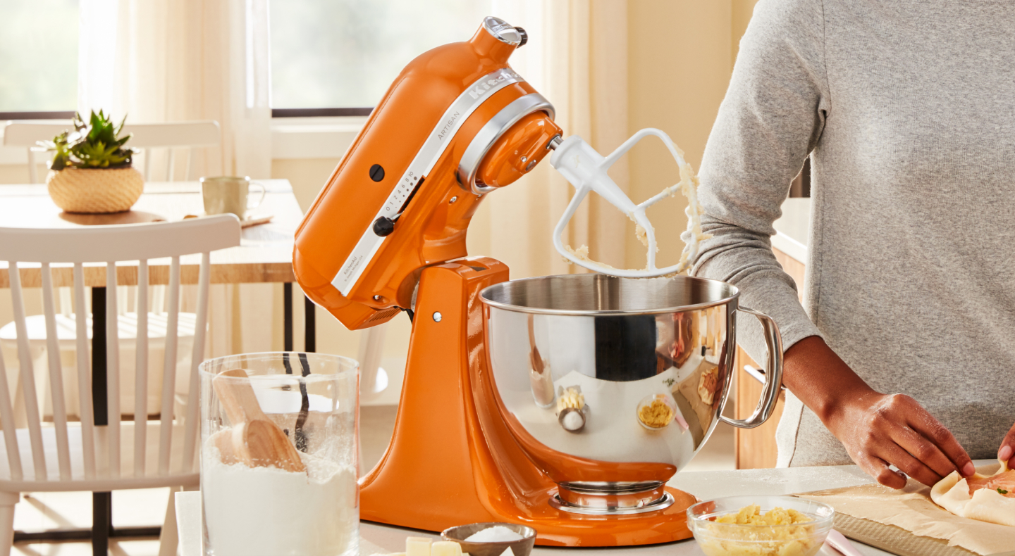 Flat beater attachment on orange KitchenAid® stand mixer Flat beater attachment on orange KitchenAid® stand mixer