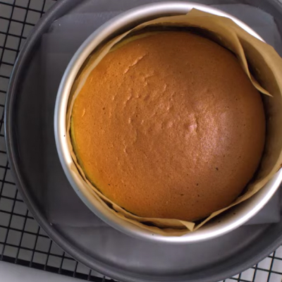Cake in pan with parchment paper.