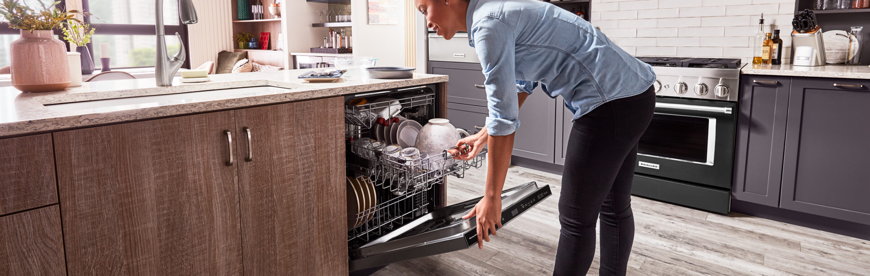 Person closing a loaded dishwasher 