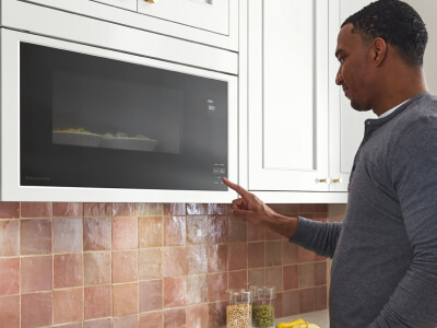 Person selecting a setting on a microwave