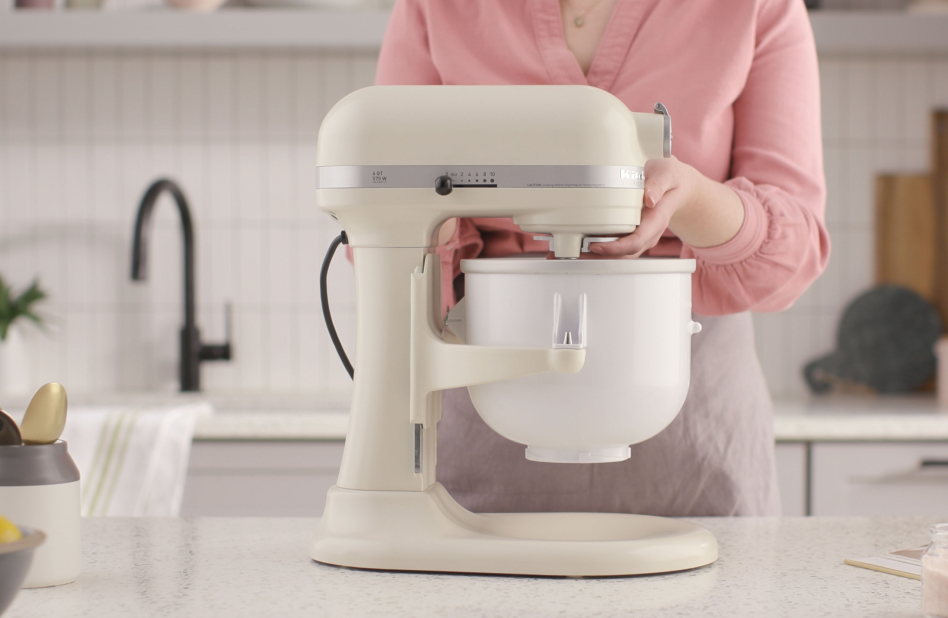 Woman attaching Ice Cream Maker to stand mixer Woman attaching Ice Cream Maker attachment to stand mixer