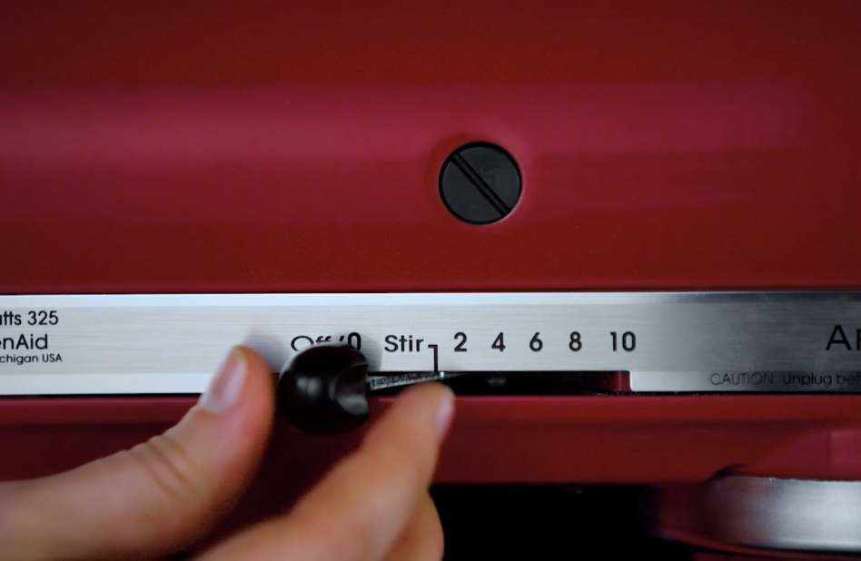 Hand sliding the lever to Stir speed on stand mixer Hand sliding the lever to Stir speed on stand mixer