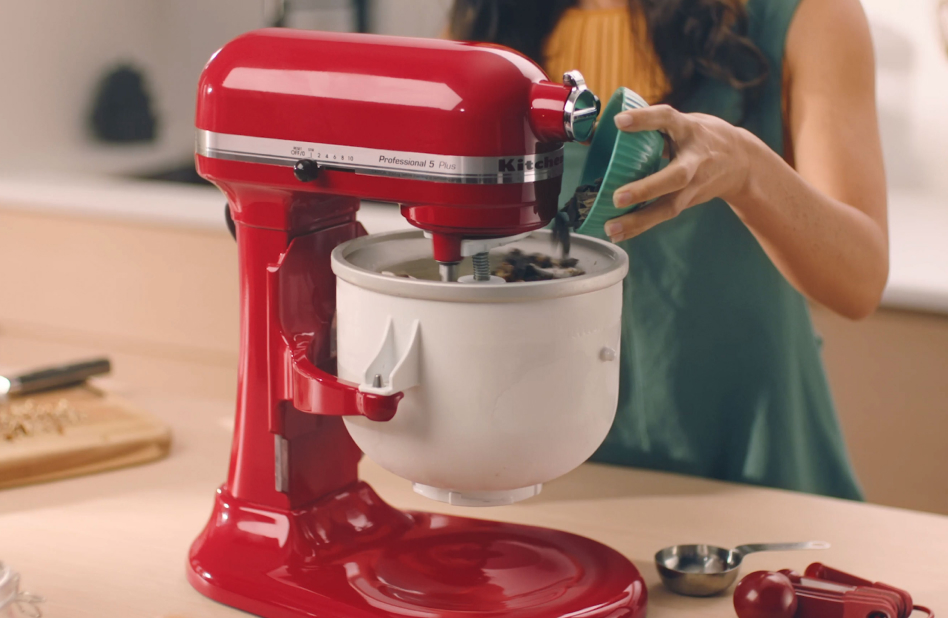 Woman pouring chocolate chips into KitchenAid Ice Cream Maker bowl Woman pouring chocolate chips into KitchenAid® Ice Cream Maker bowl
