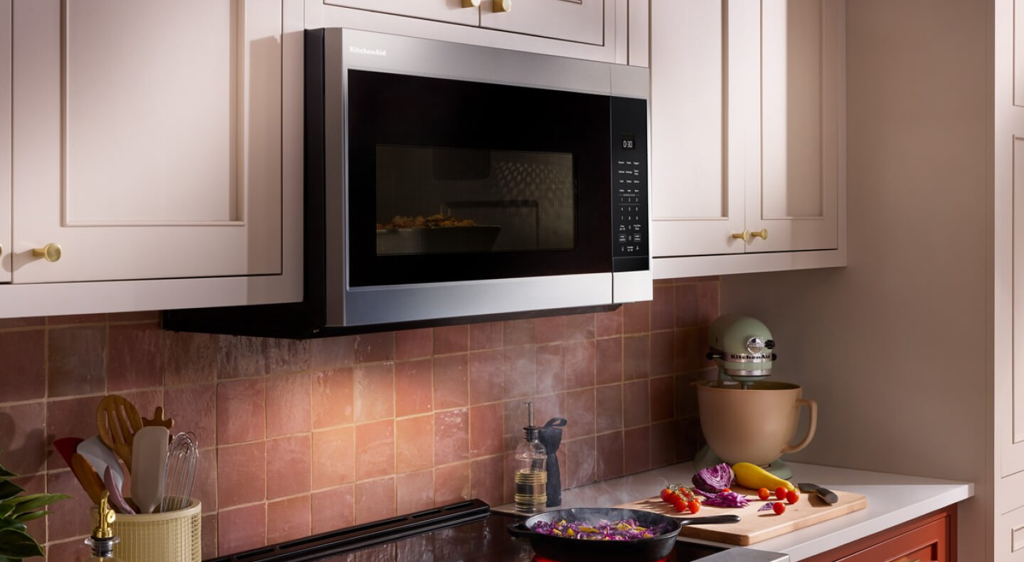 KitchenAid® over-the-range microwave above brick-colored backsplash KitchenAid® over-the-range microwave above brick-colored backsplash