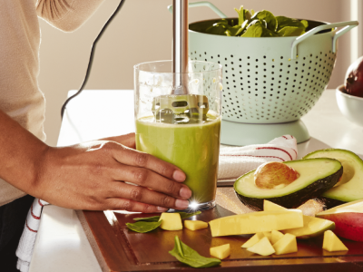 Blending an avocado smoothie in a drinking glass