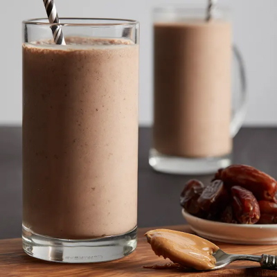 Two brown smoothies with straws