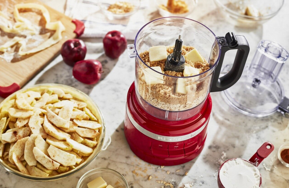 View of KitchenAid® food processor next to an apple pie