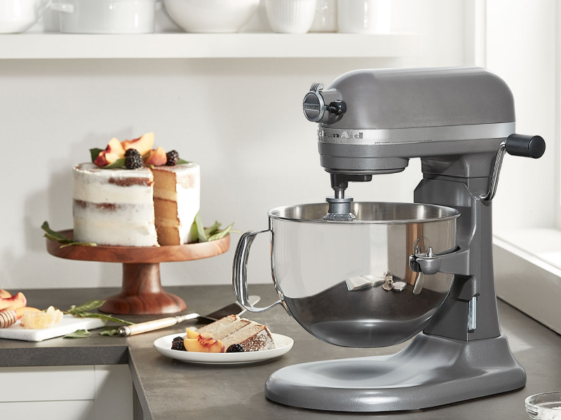 KitchenAid® bowl lift stand mixer next to layer cake on cake stand  KitchenAid® bowl lift stand mixer next to layer cake on cake stand