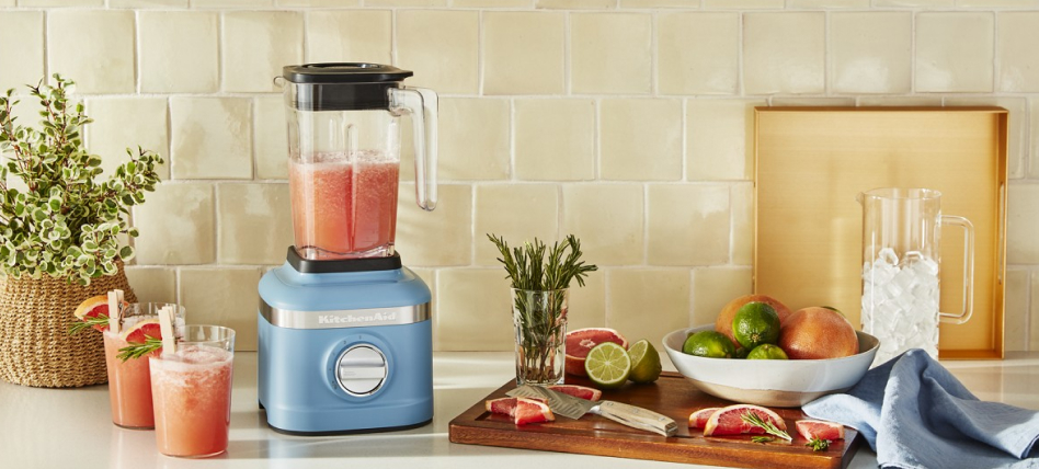 Blue velvet KitchenAid® blender with fruit and glasses of smoothies Blue velvet KitchenAid® blender with fruit and glasses of smoothies