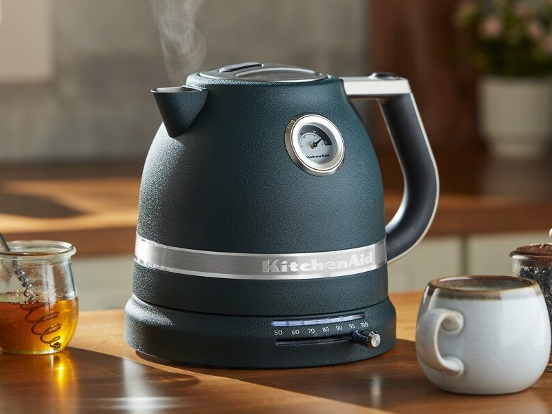 Black KitchenAid® electric kettle next to tea accessories and honey Black KitchenAid® electric kettle next to tea accessories and honey