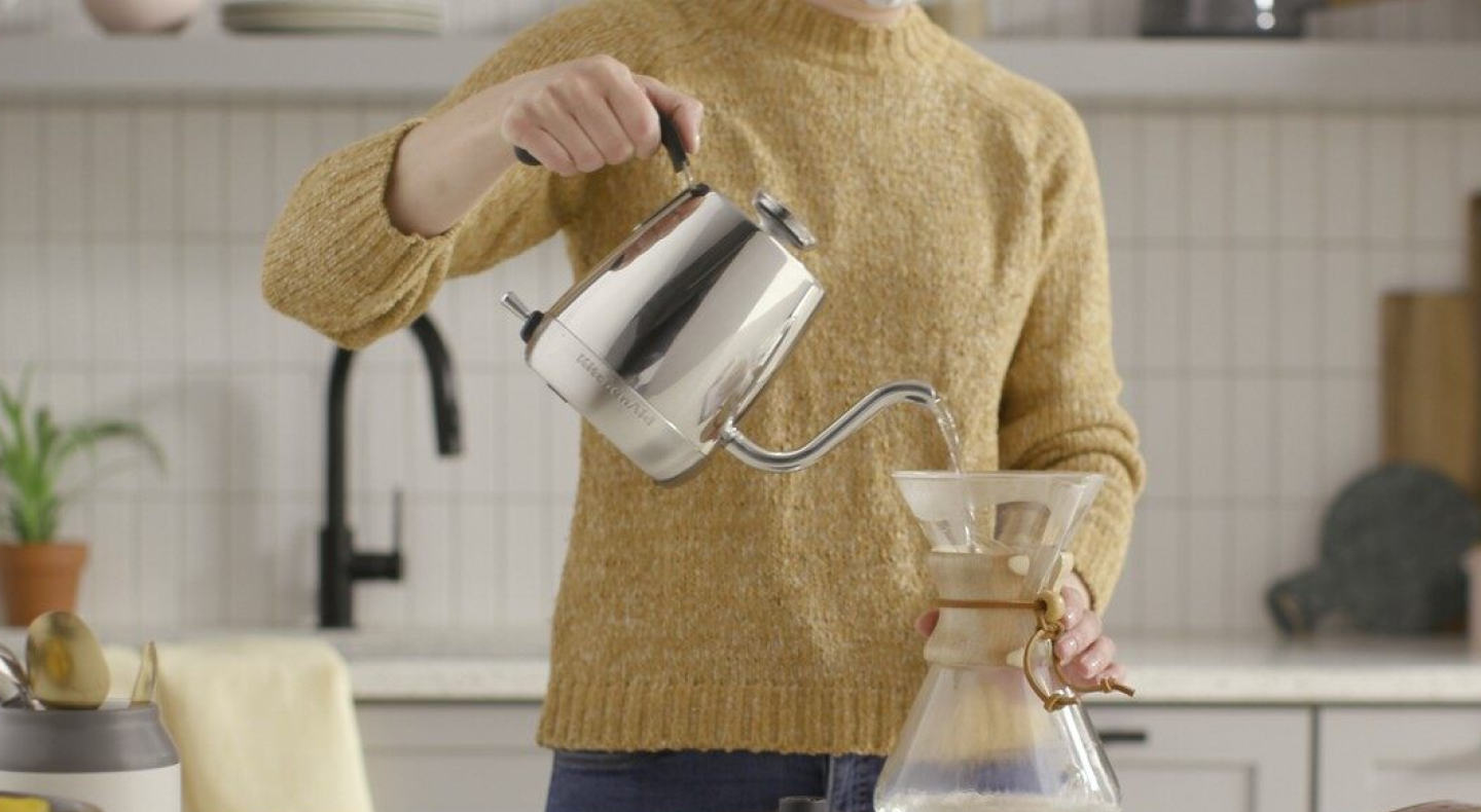 Woman making pour over coffee with a gooseneck kettle Woman making pour over coffee with a gooseneck kettle