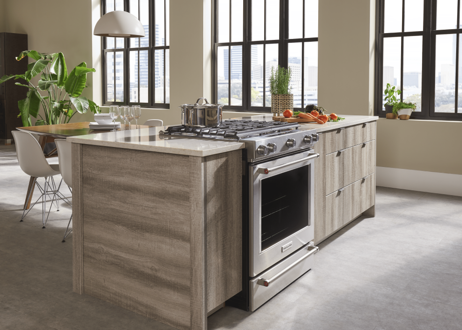 KitchenAid® gas range built into a kitchen island with a pot on top  KitchenAid® gas range built into a kitchen island with a pot on top