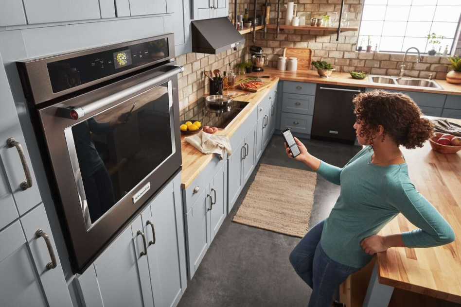 Person on phone in front of wall oven Person on phone in front of wall oven