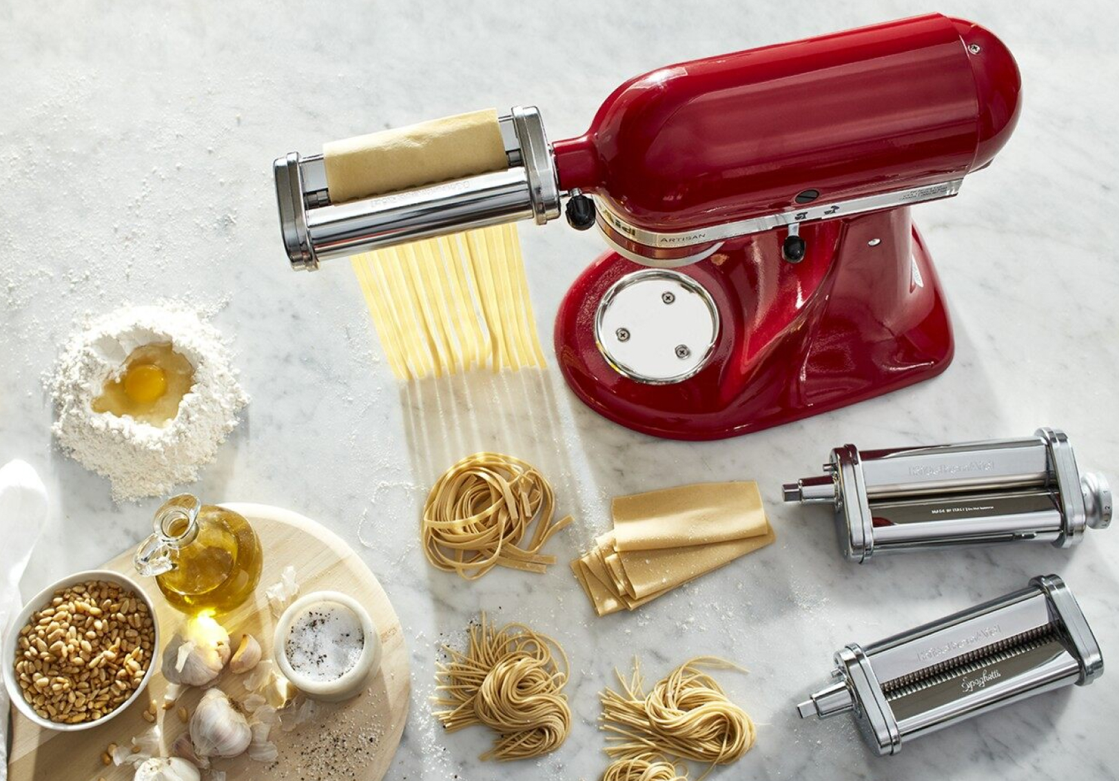 Red KitchenAid® stand mixer with the Pasta Sheet Roller Attachment rolling and cutting pasta Red KitchenAid® stand mixer with the Pasta Sheet Roller Attachment rolling and cutting pasta