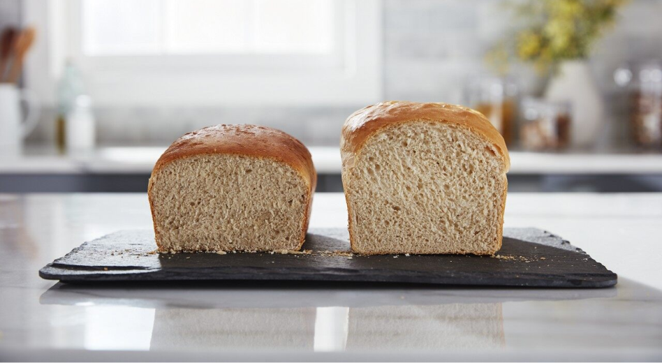 Split loaf of homemade bread on cutting board Split loaf of homemade bread on cutting board