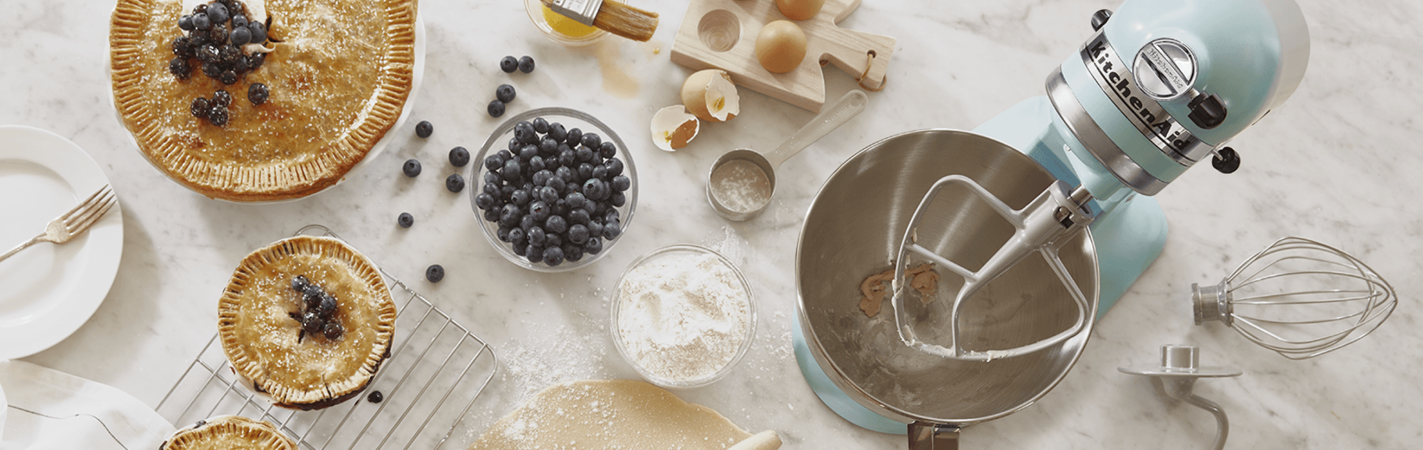 KitchenAid® stand mixer with blueberry pie, tarts, ingredients and homemade pie dough