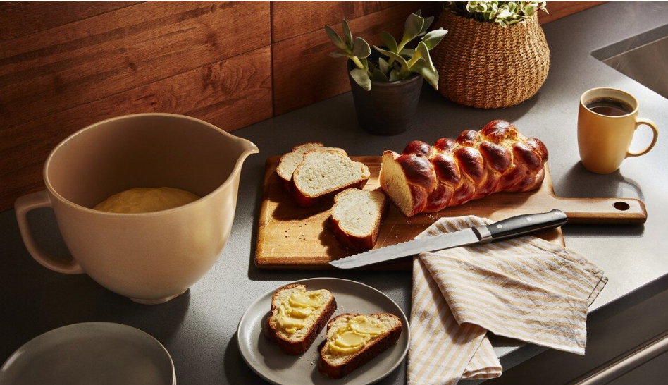 Freshly baked bread on a countertop next to a mixing bowl Freshly baked bread on a countertop next to a mixing bowl