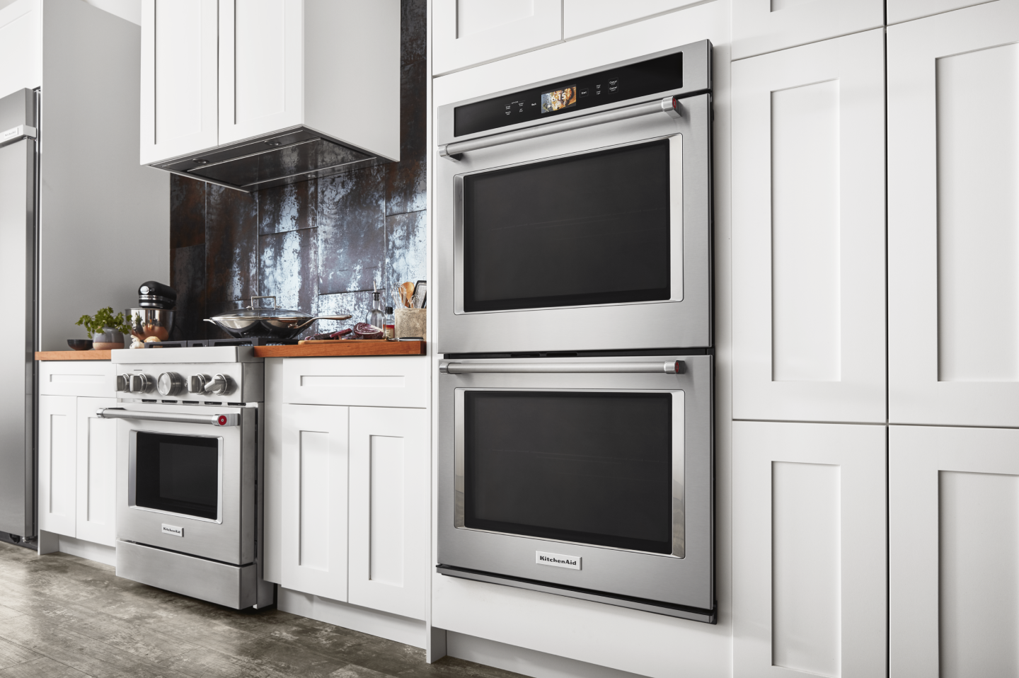 Kitchen with white cabinetry and a stainless steel oven and gas range