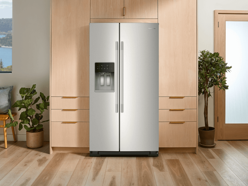 Stainless steel refrigerator surrounded by wooden cabinetry