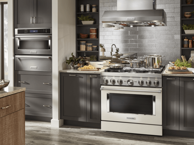 Kitchen with dark gray cabinets and stainless commercial-style range 
